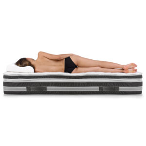 Portrait of a woman lying on a mattress.